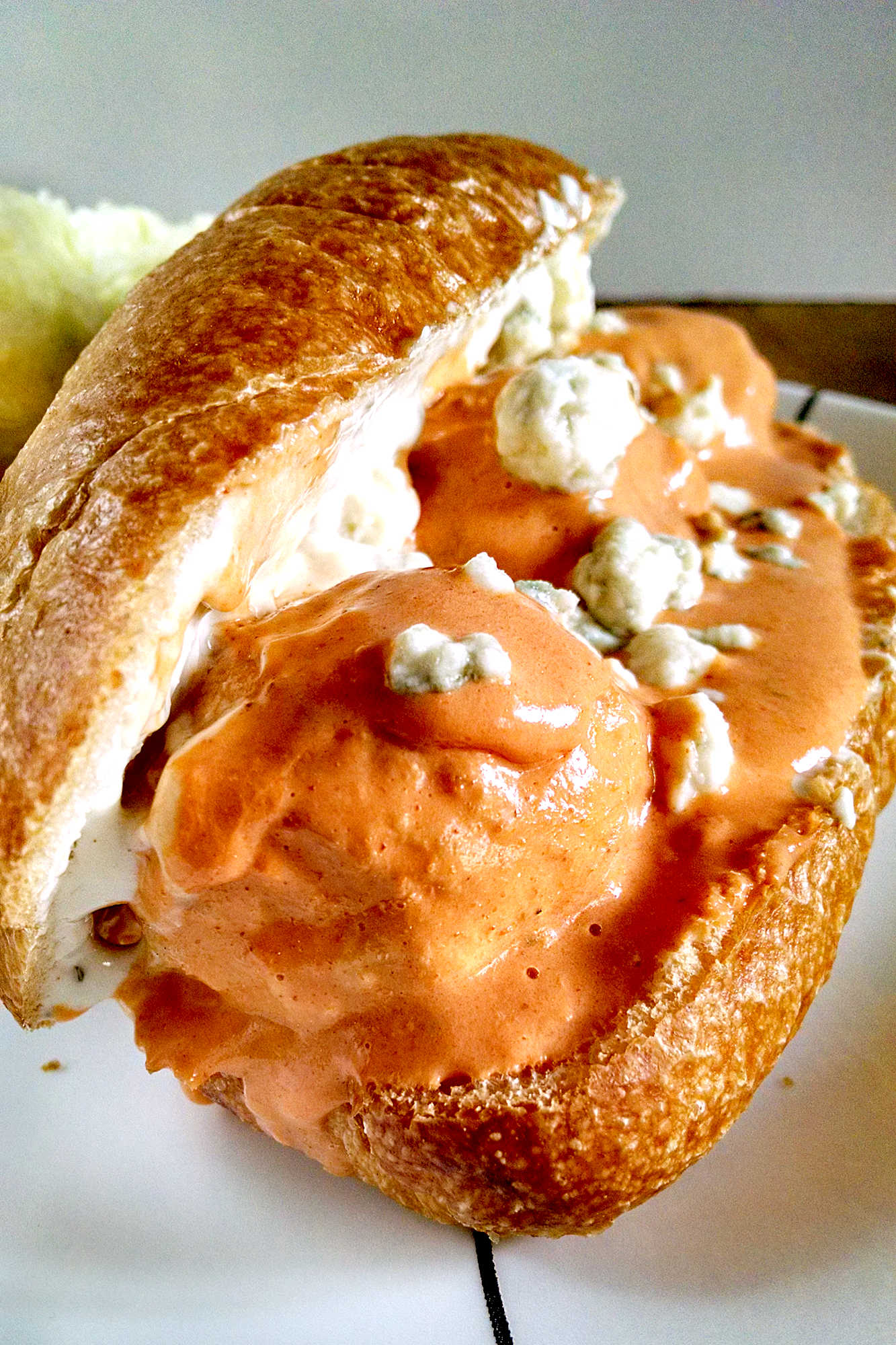 Slow Cooker Buffalo Chicken Meatball Sliders tasty amazing and perfect for any tailgate party.  Spicy wing sauce is mixed with cool ranch dressing and poured over these Buffalo chicken meatballs which are slow cooked and perfect for your tailgate party! #SlowCookerMonth #SlowCookerSliders #BuffaloChickenMeatballs #GameDayEats #CrockPotCooking #EasyAppetizers