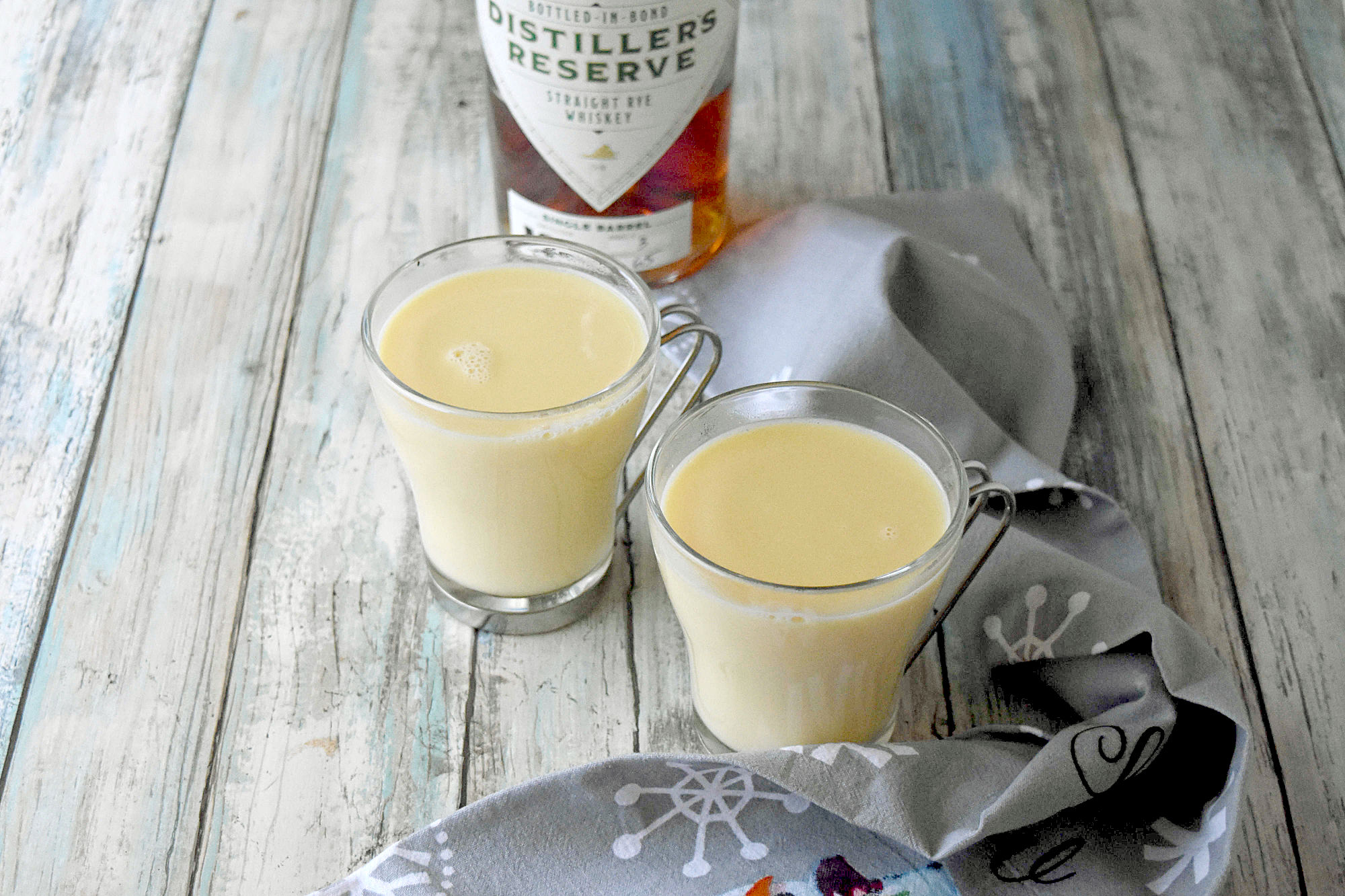 Spiked Eggnog White Hot Chocolate is full of eggnog flavor and rich with white chocolate.  It has a kick from the Distiller’s Reserve Bottled-in-Bond Rye Whiskey. #OurFamilyTable