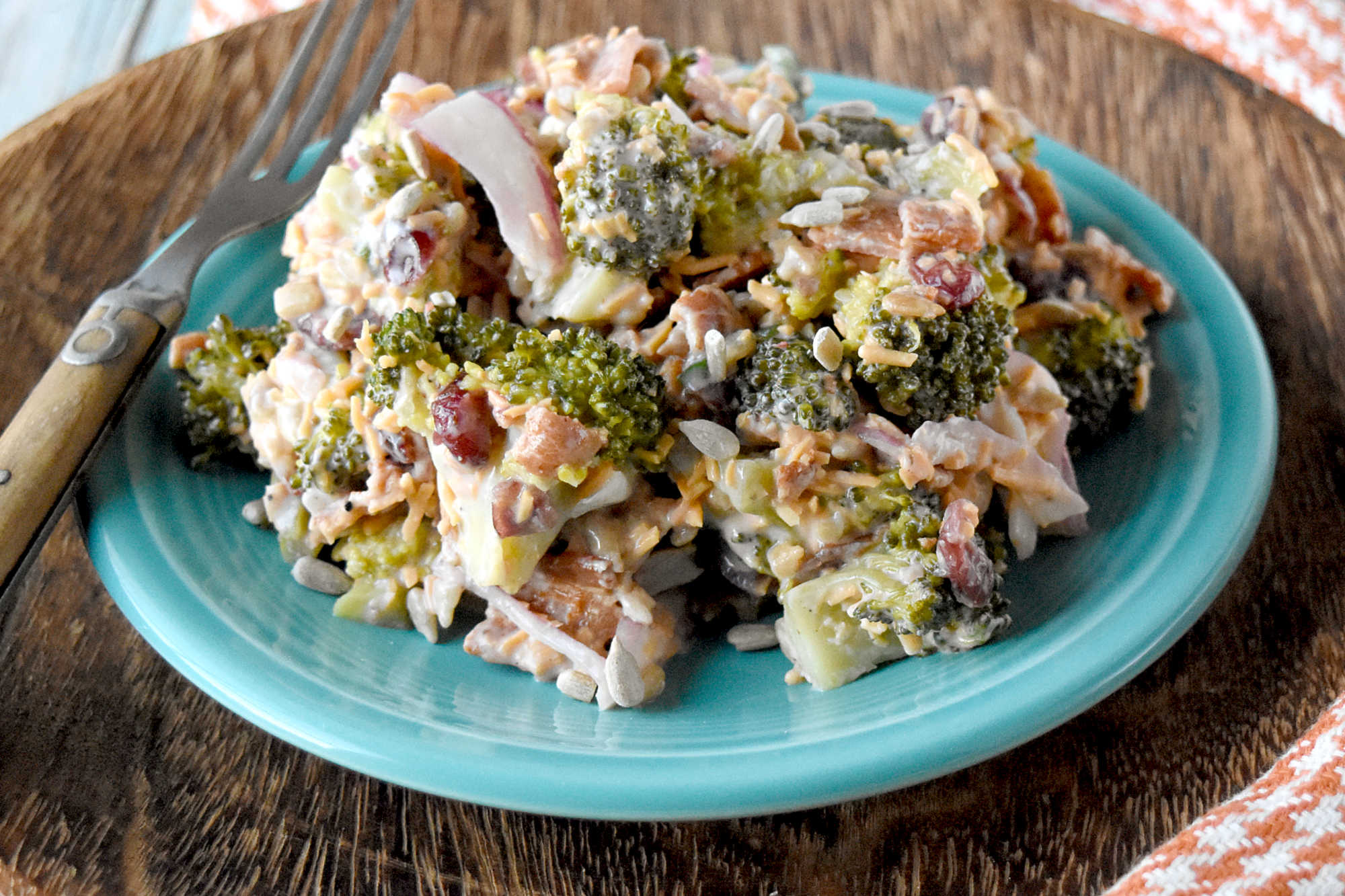 Skip the boring side salads and try this Creamy Broccoli Salad instead! Bursting with flavor and nutrients, it's the perfect accompaniment to any holiday meal. #healthyeating #creamysalad #cleaneating #broccolisalad #SaladLoversUnite #VeggieDelight  #EatYourGreens #holidaysidedish #sidedishrecipe #sidesalad
